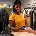 Customer checking out at a partner store with her phone